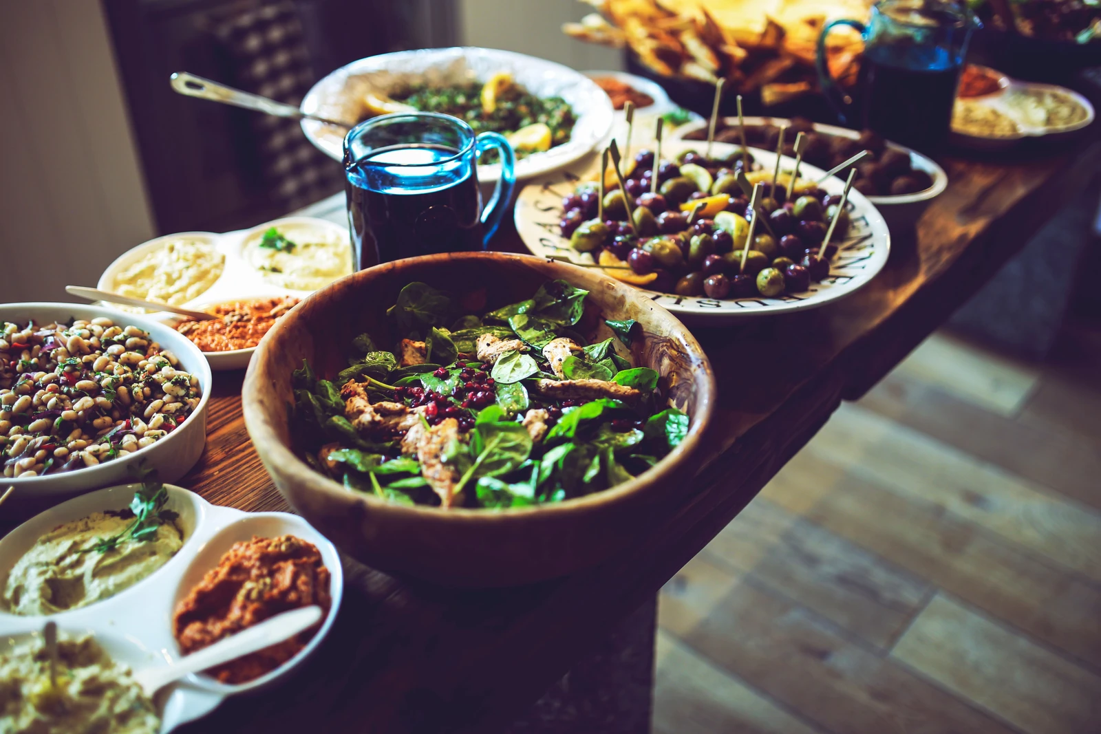 A shared table with salads, olives and colourful meze dishes